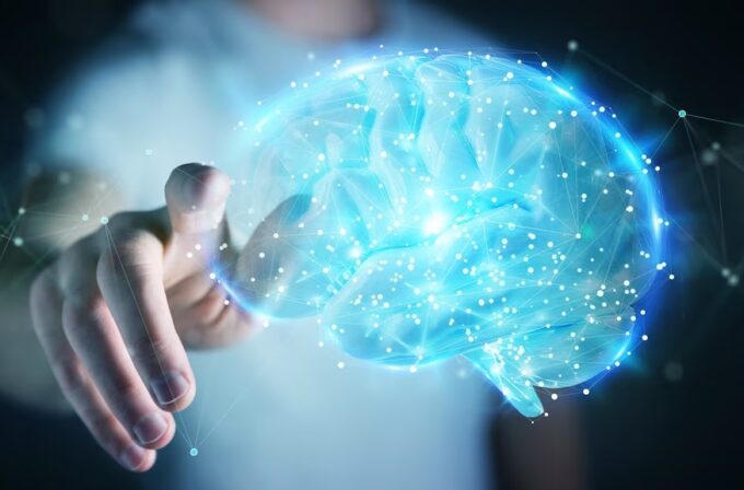 Immagine di un cervello in AI con mano che cerca di toccarlo. Conseguenze